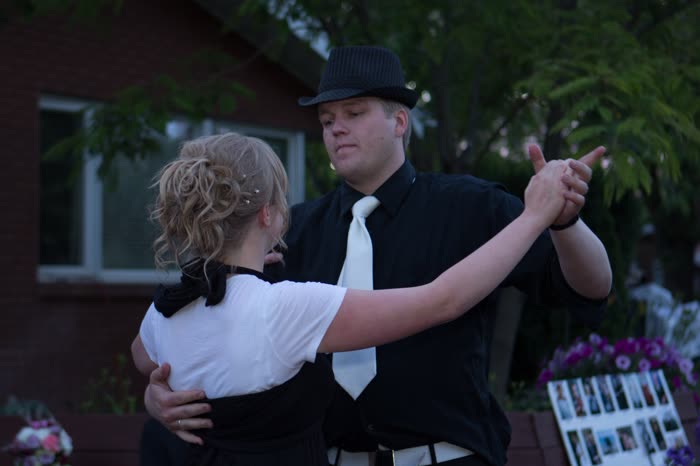 Couple in white tie and dress swing dancing